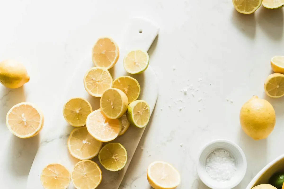 Sliced lemons on a white plate and table