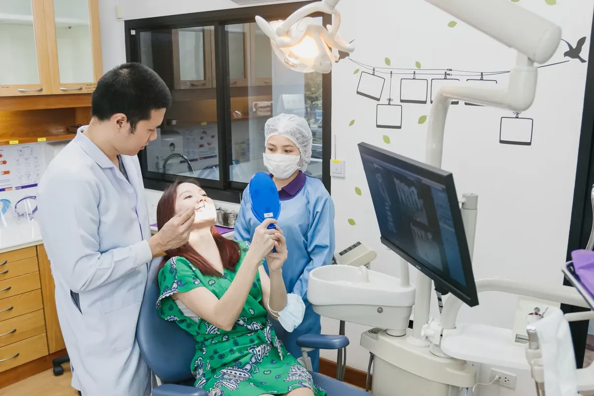 A dentist at Kitcha Dental Clinic checking a patient in the dental chair