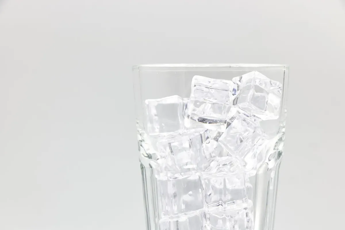 A glass filled with ice cubes on a white background