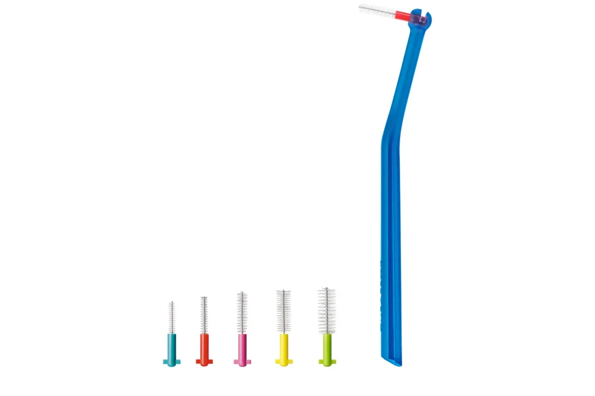 An interdental brush holder with five interdental brush heads in different sizes and colors, from thin to thick