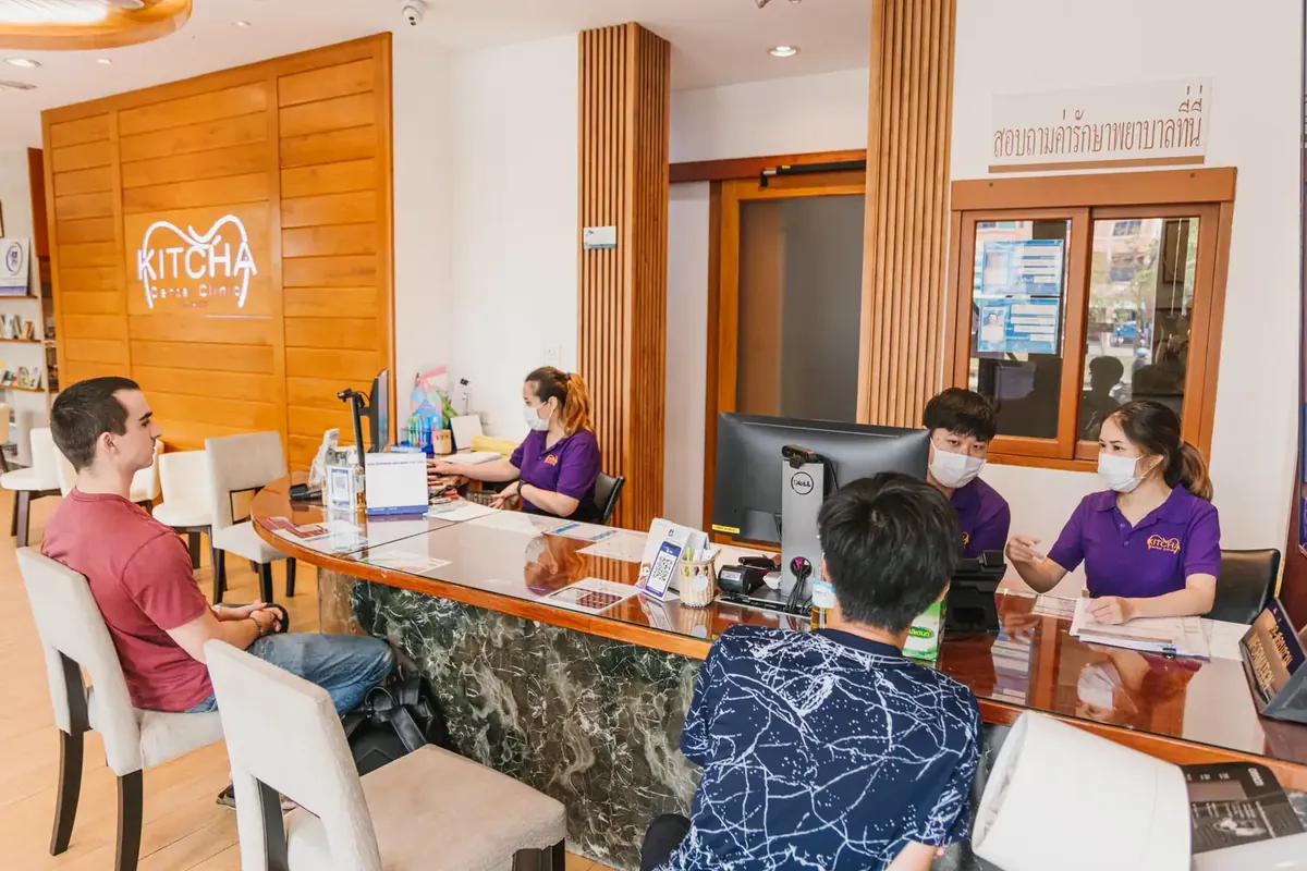 Patients talking with the reception team at the clinic front desk